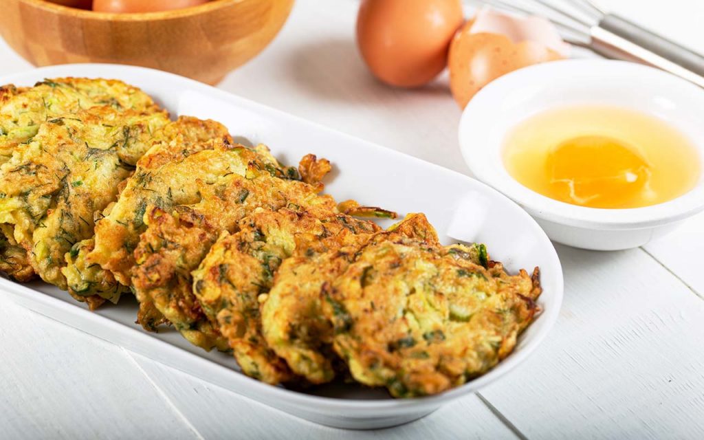 Mücver (Zucchini Fritter) served on a long plate.