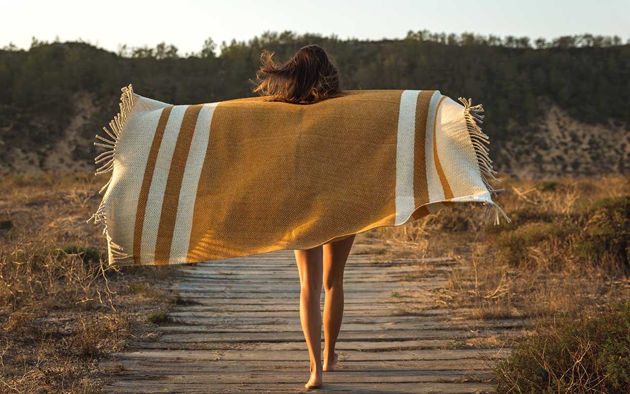 woman holding travel blanket