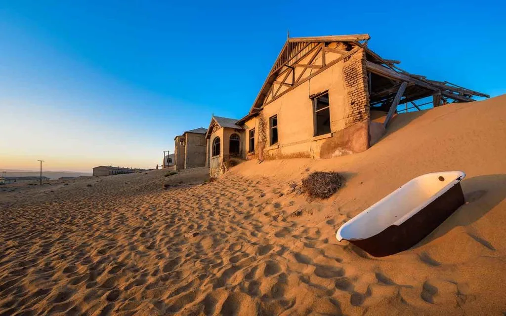 Empty bathtub n the sand desert ghost town of Kolmanskop