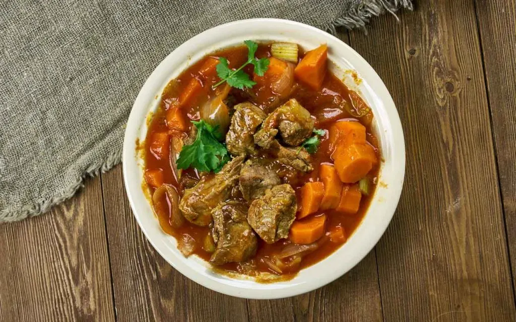 Welsh food: lamb soup (cawl) in a white bowl