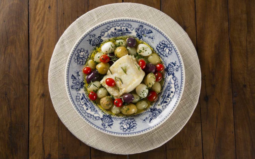 Portuguese Food: Bacalhau (Salted Cod) - presented on a wooden table