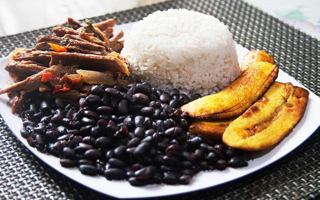 Venezuelan Food: Pabellón Criollo (Rice, Plantain, Beans, and Beef) on a plate.
