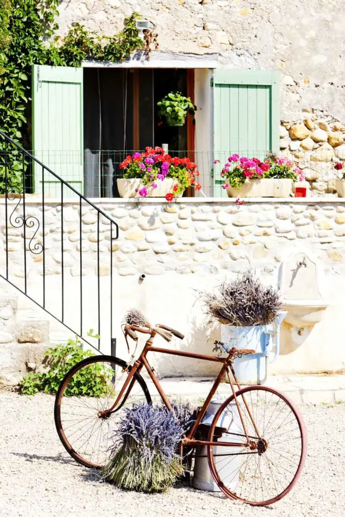 Bike against a beautiful background of stone walls and flowers.