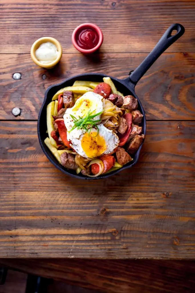 Chilean food: Chorillana (French Fries Topped with Meat, Onions, and Fried Eggs)