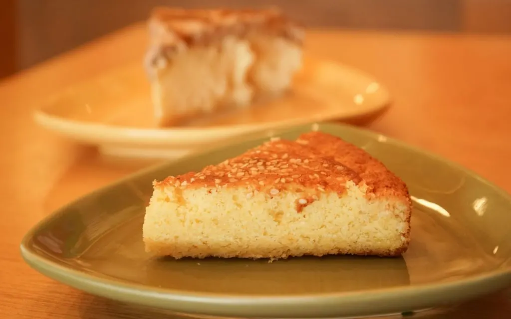 A slice of Salvadoran quesadilla (cheese cake) on a  small plate on the table.
