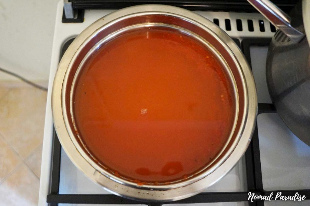 Tomato passata and bors acru in a pot.
