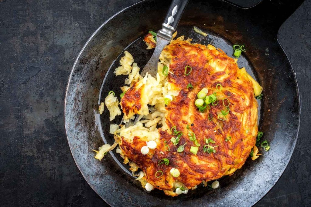 Rösti (Grated Potatoes) in a pan.