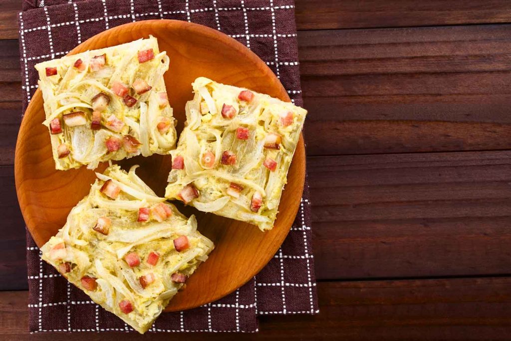 Schaffhauser Bölletünne (Onion Tart) squares on a plate.