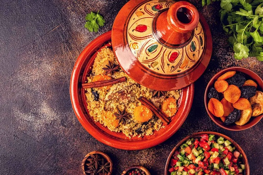 Tajine in a the traditional ceramic pot tajine in the middle of a table