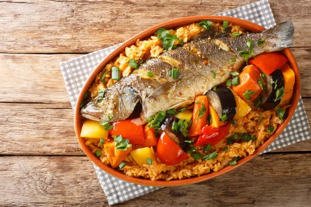 Thieboudienne in an oval-shaped dish on the table