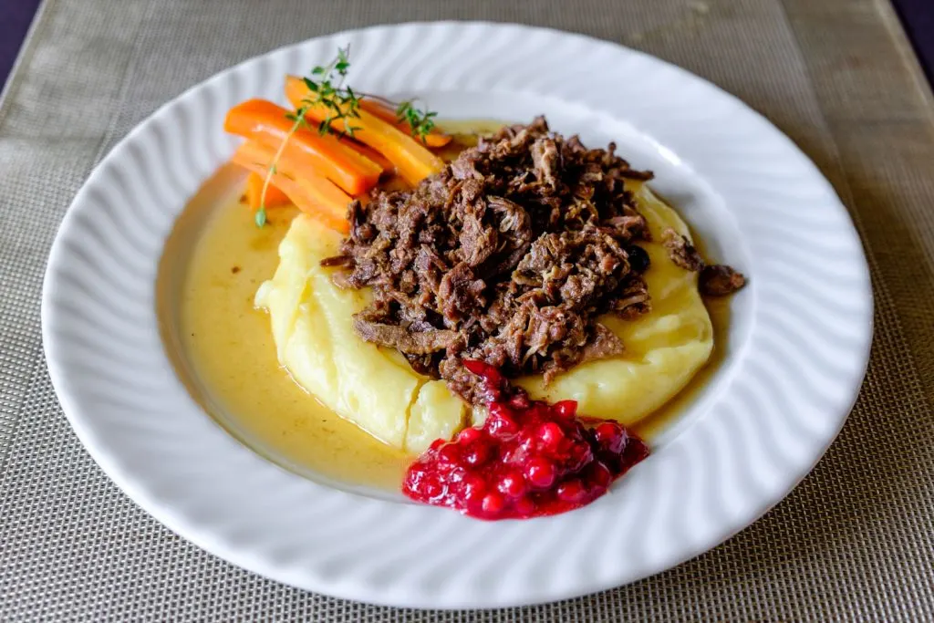 Poronkäristys (Sautéed Reindeer) with mashed potatoes, carrots, and lingonberry jam.