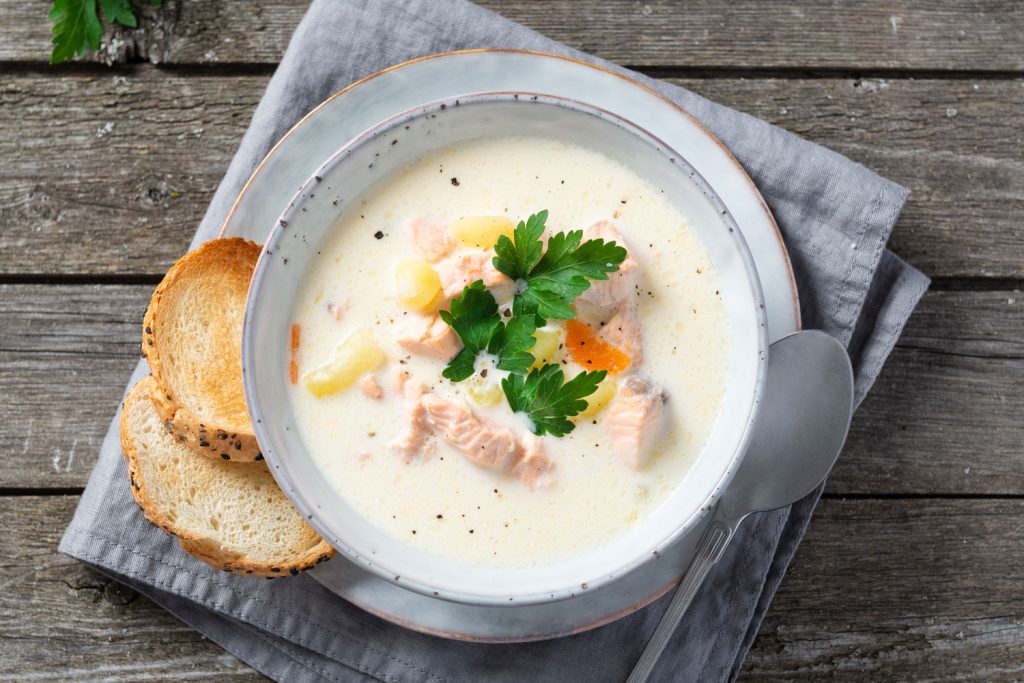 Lohikeitto (Salmon Soup) with two slices of bread.