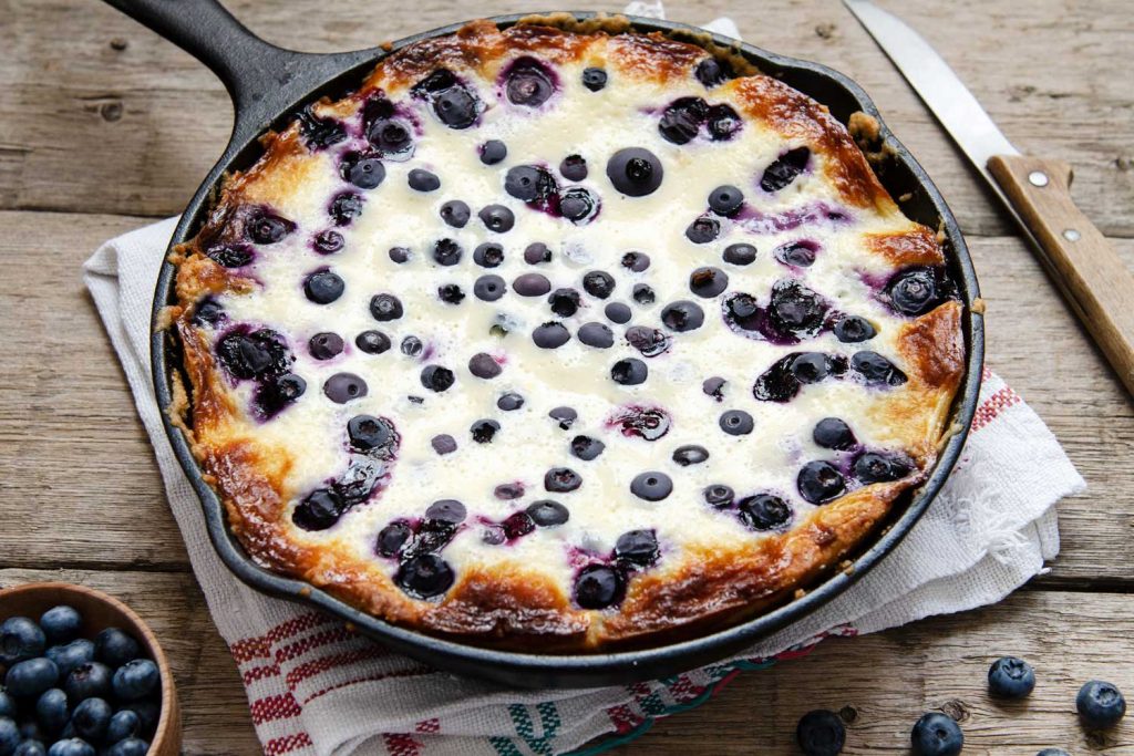 Freshly baked Mustikkapiirakka (Blueberry Pie) in a skillet.


