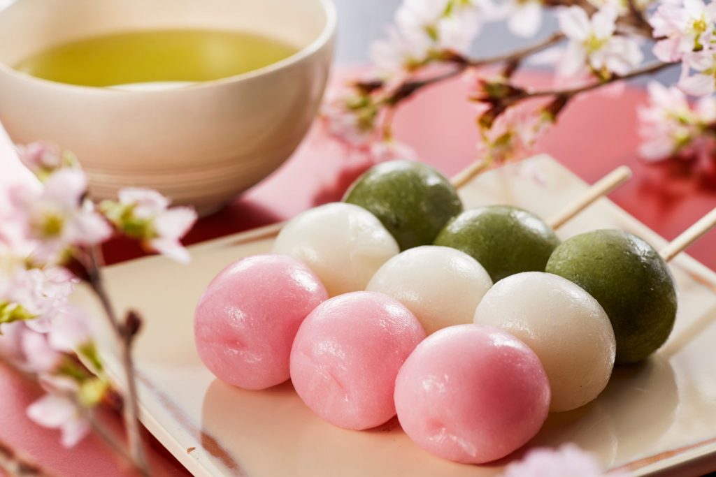 Dango (Sticky Rice Cake Balls on a Stick) with a cup of green tea.