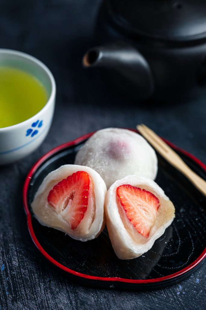 Japanese dessert - strawberry daifuku (mochi balls filled with sweet bean paste and strawberries).