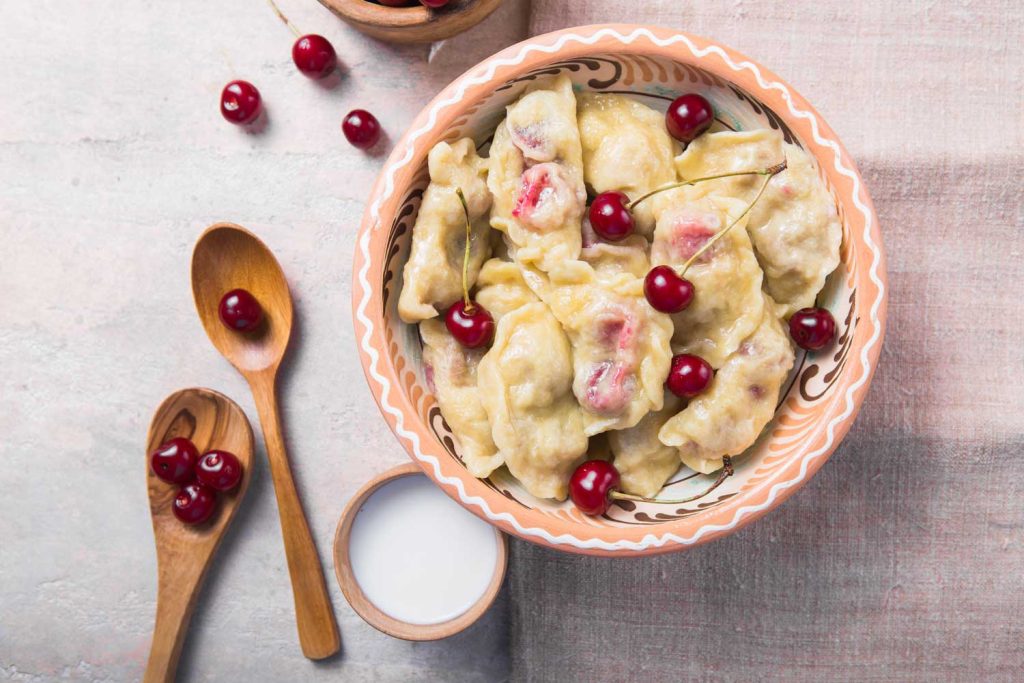 Varenyky with Cherries (Вареники з вишнею) – cherry-filled dumplings with cherries on top.