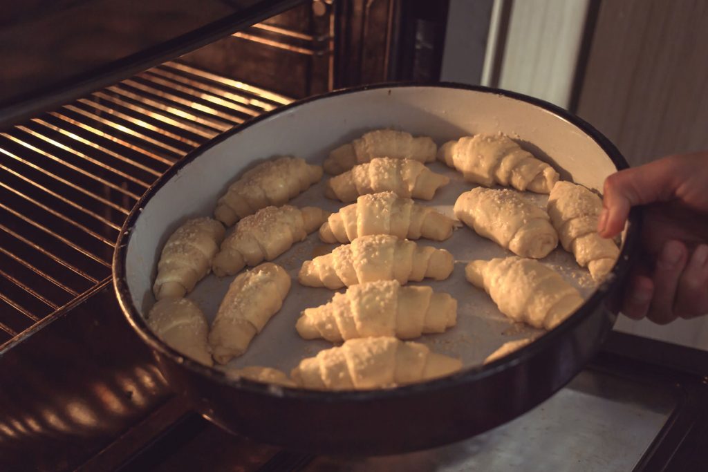 Kiflyky (Кіфлики) – Ukrainian Crescent Rolls going into the oven.