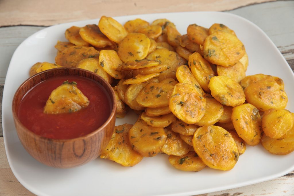 Bhajias (Potato Fritters) served on a white dinner plate.