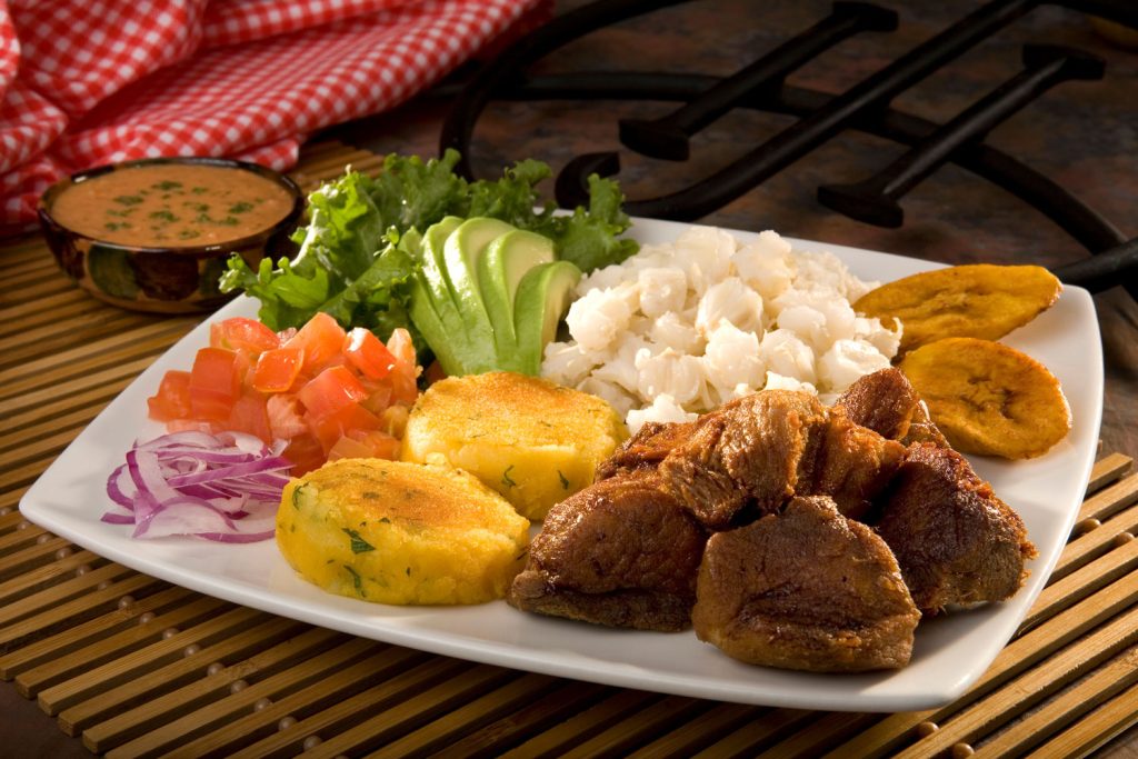 Fritada (Fried Platter with Pork Bites, Potatoes, Corn, and Fried Plantains).