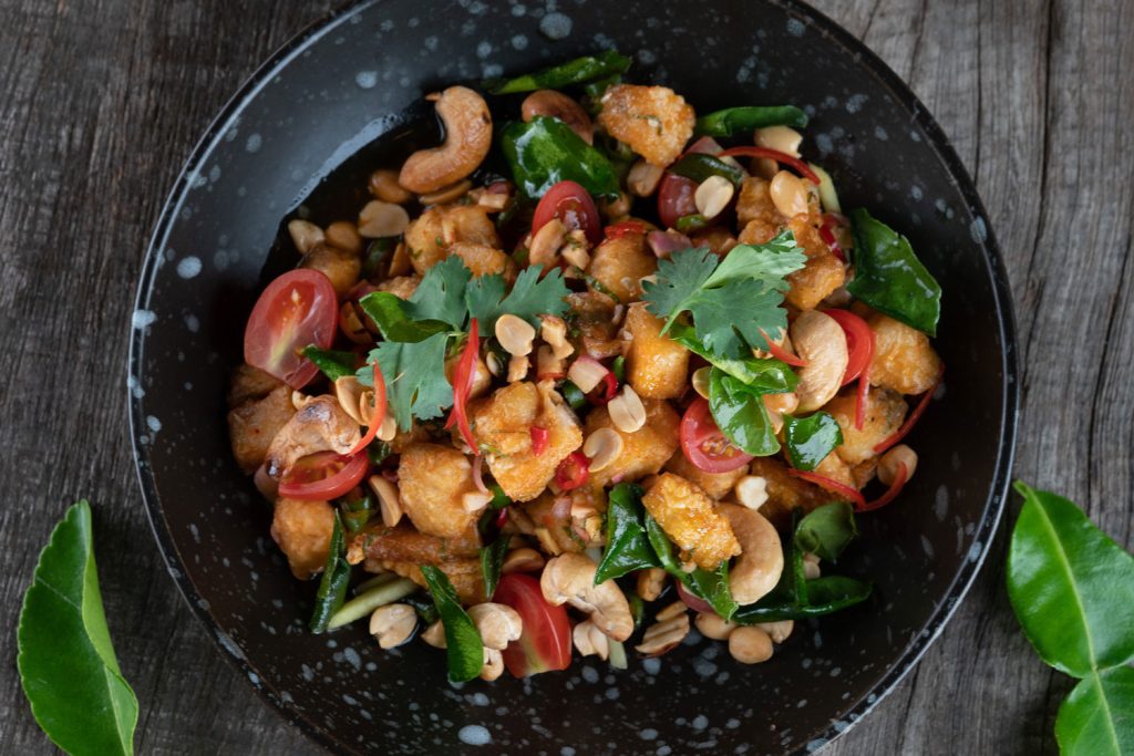 Stir-fried chicken with cashew nuts served in a bowl.