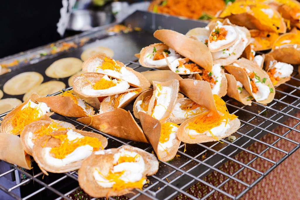 Crispy Thai pancakes being sold by street vendor.