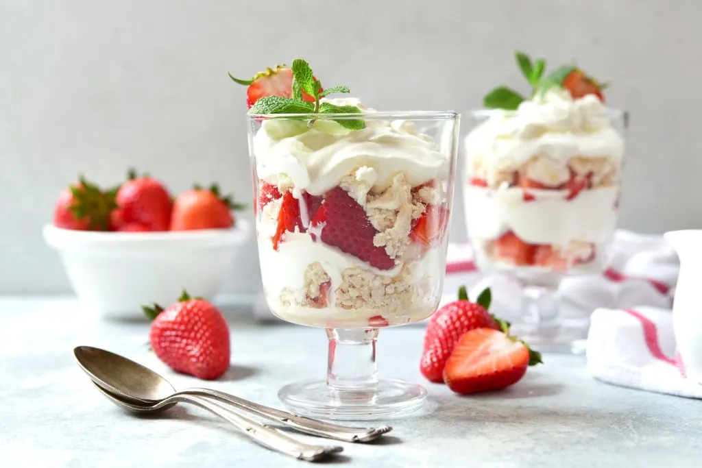 Eton mess with strawberries in a glass jar.