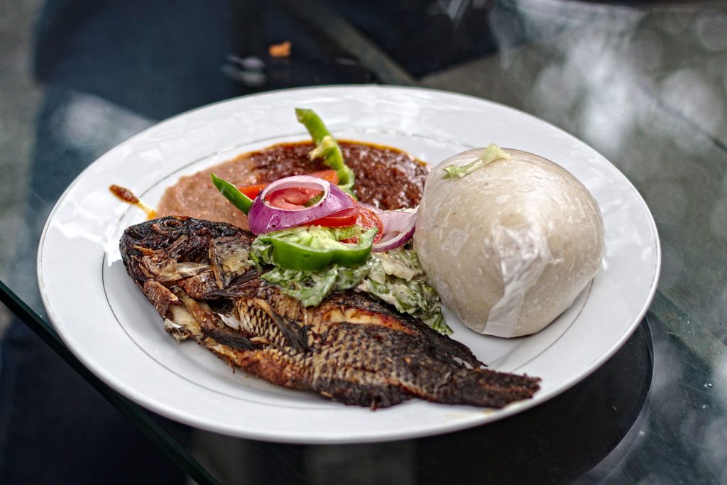 Banku with fish and sides/sauces.