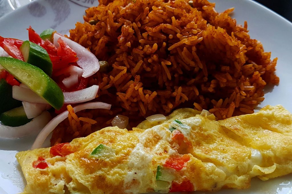 Jollof with eggs and salad.