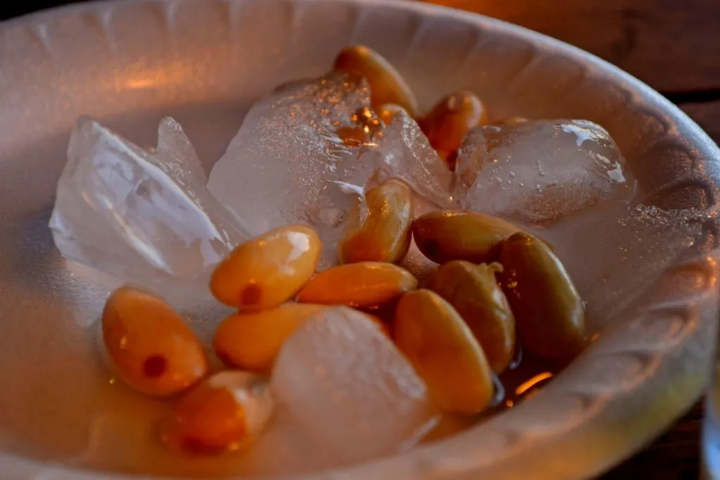 A plate of almonds on ice.