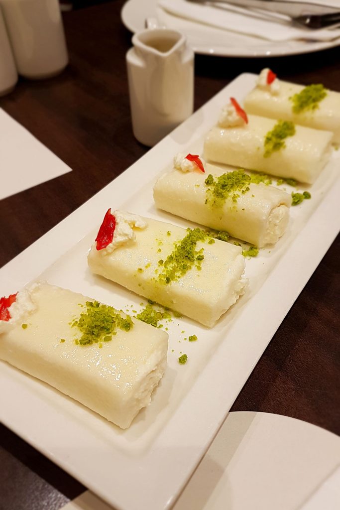 Lebanese dessert Halawet el Jibn served on a white rectangular plate.