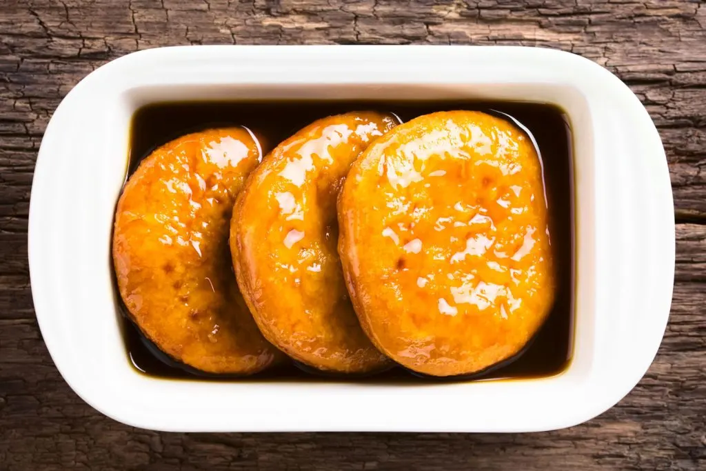 Sopaipillas (Fried Bread Discs) in chancaca.