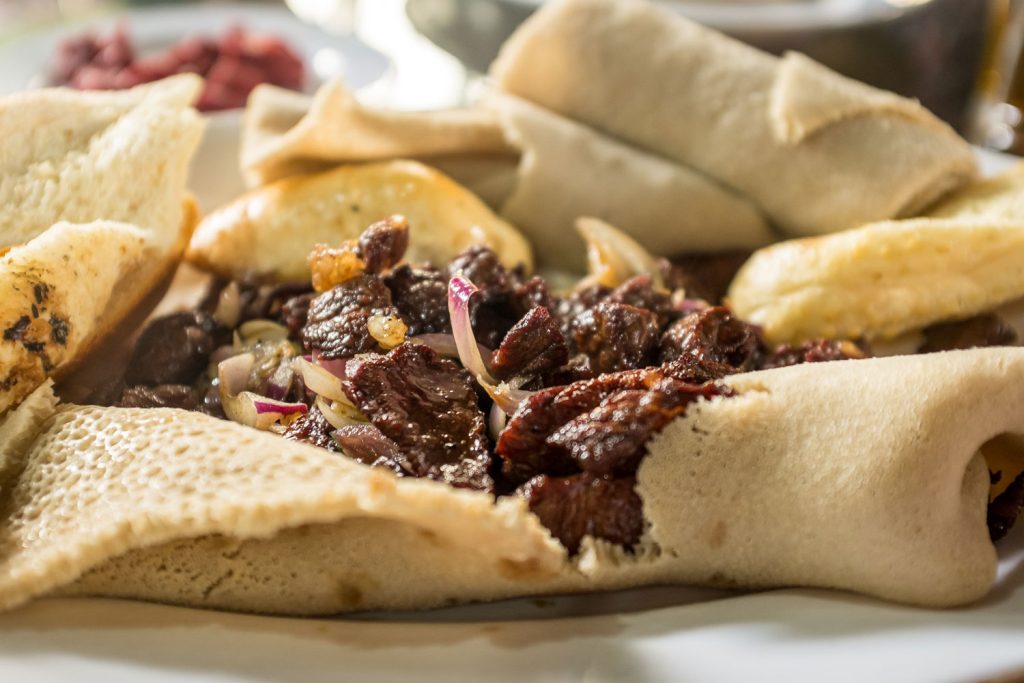 Tibs (Lightly Fried Meat Slices) with injera.