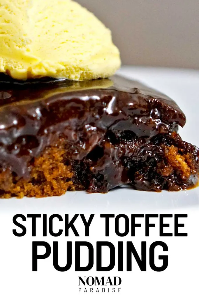 Sticky toffee pudding served with a scoop of ice cream on top.