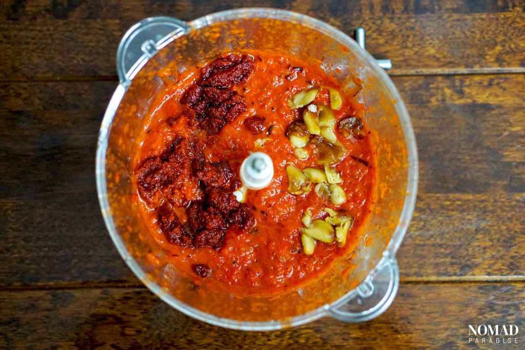 Muhammara recipe step by step (peeled roasted peppers and garlic and tomato paste with spices in the food processor).