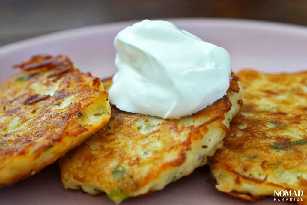 Draniki potato pancakes topped with sour cream.