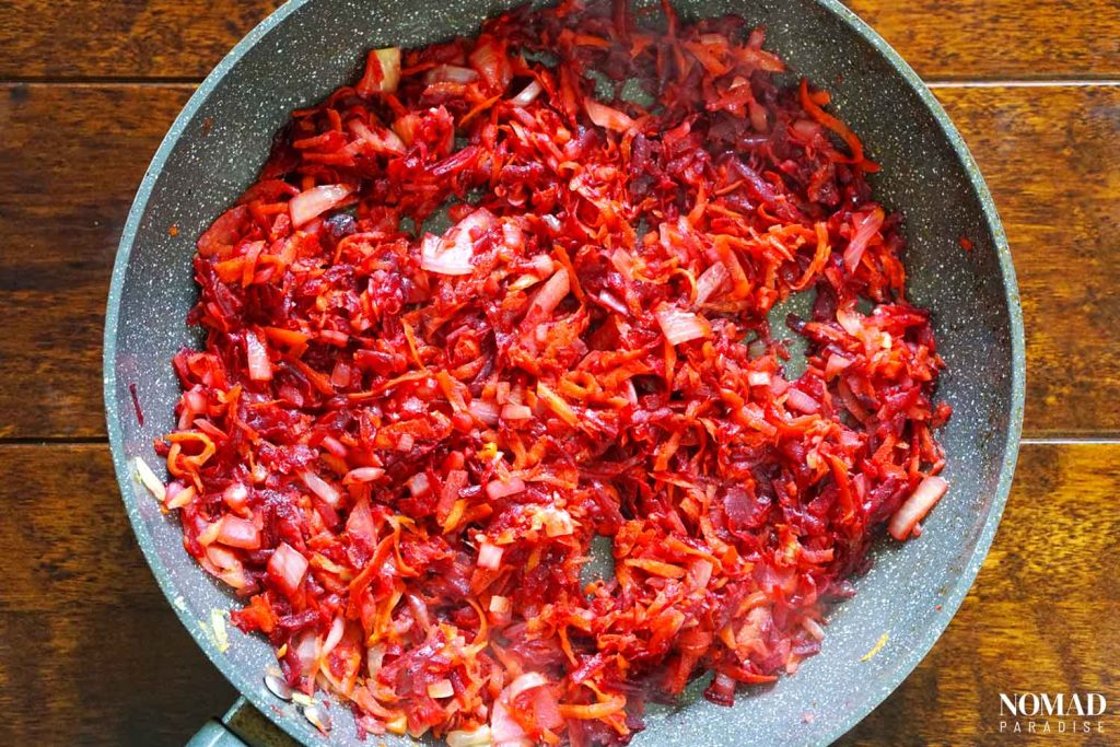 Borsch recipe step-by-step (sauteed onions, carrots, beets, and spices in a pan).