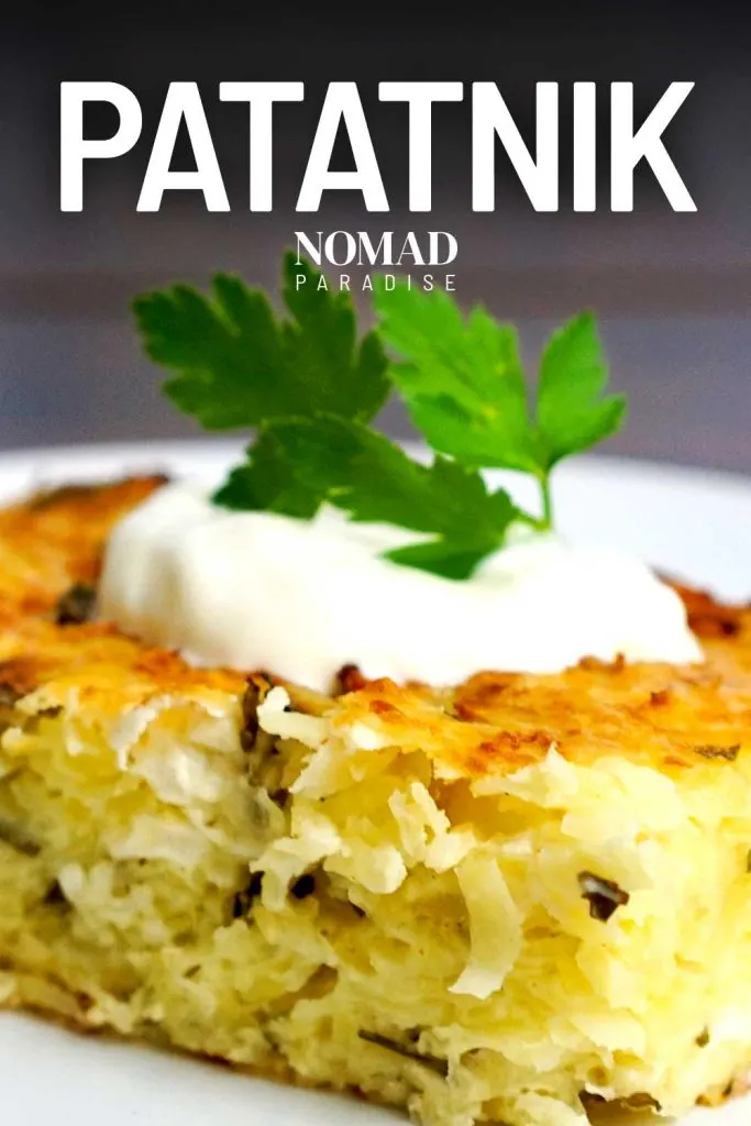 Patatnik topped with sour cream and parsley.