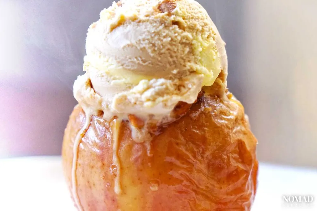 Baked apple with a scoop of ice cream on top.