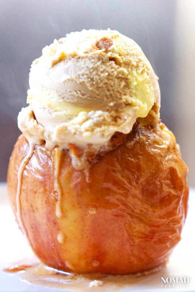 Baked apple with a scoop of ice cream on top.