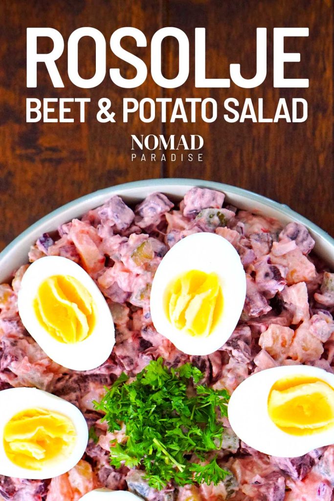 Beet and Potato Salad (Rosolje) - decorated with halved boiled eggs and parsley.