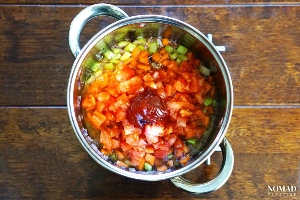 Greek Bean Soup Recipe (Fasolada) - step-by-step: adding the tomato paste and tomatoes.
