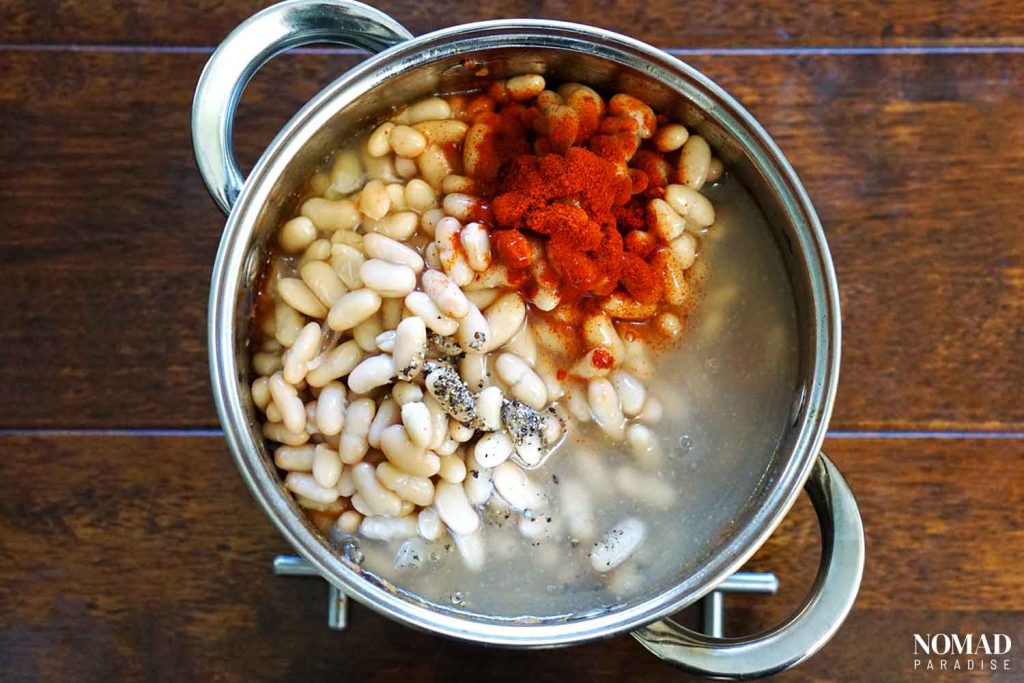 Greek Bean Soup Recipe (Fasolada) - step-by-step: adding the black pepper and paprika.