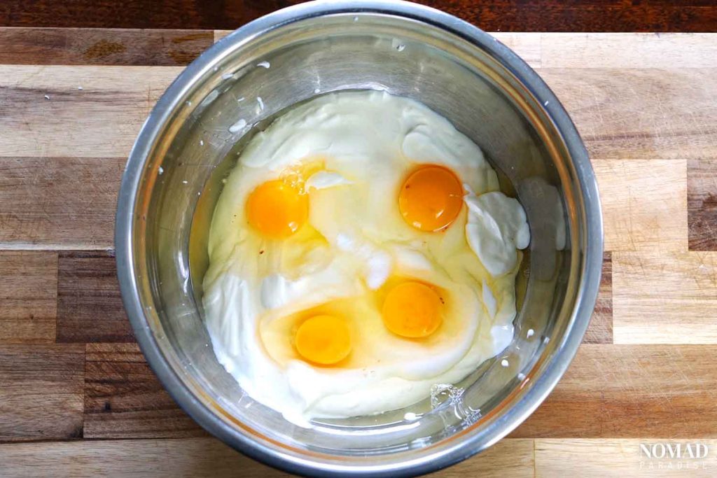 Homemade Farmer's Cheese Recipe step-by-step (yogurt, eggs, salt, and sour cream in a bowl).