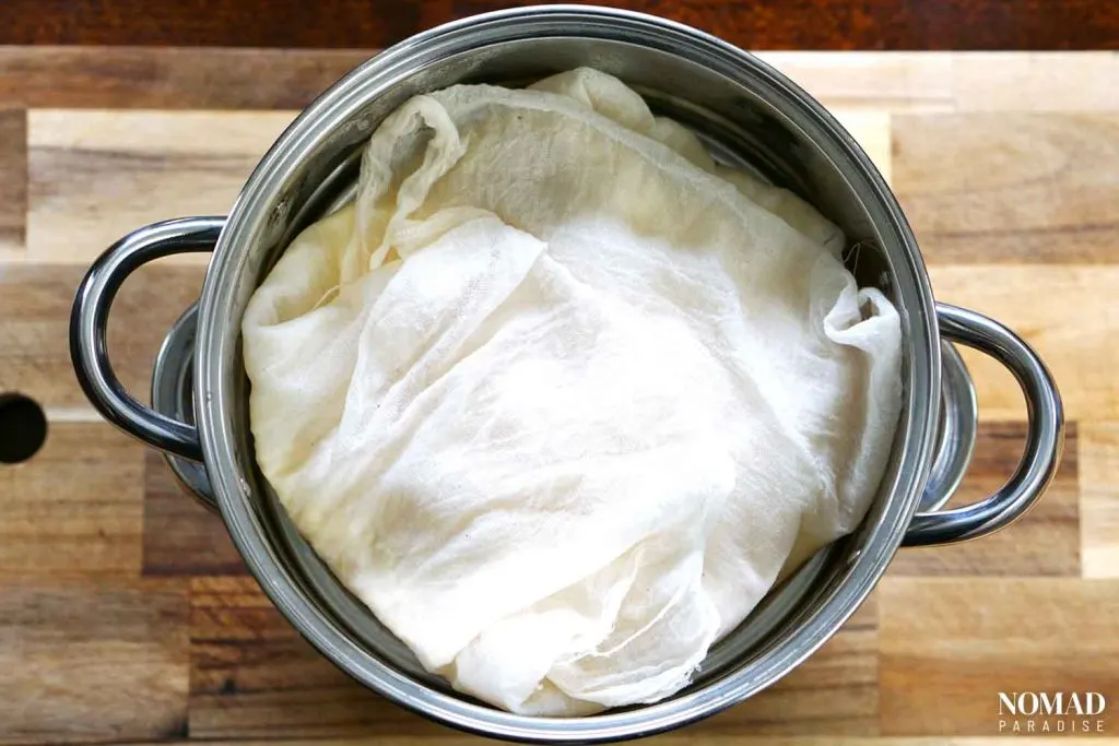 Homemade Farmer's Cheese Recipe step-by-step (covered cheese curds in the strainer).