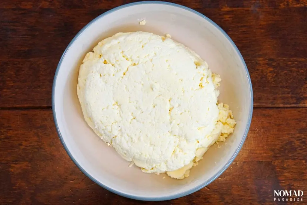 Homemade Farmer's Cheese Recipe step-by-step (finished cheese after getting out of the strainer and before cutting or crumbling it).