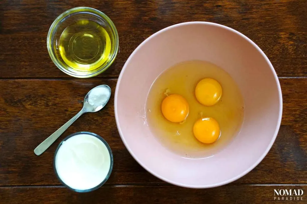 Banitsa Recipe Step by Step (mixing the eggs, oil, yogurt, and baking soda).