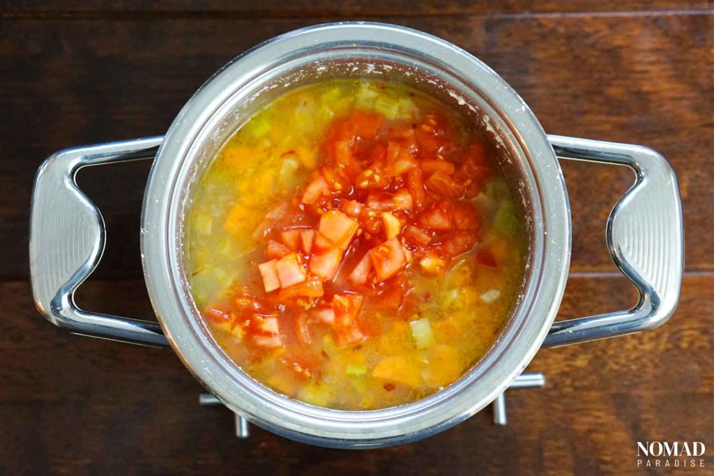 Bob Chorba step-by-step recipe (adding peeled, diced tomatoes to the pot of beans).