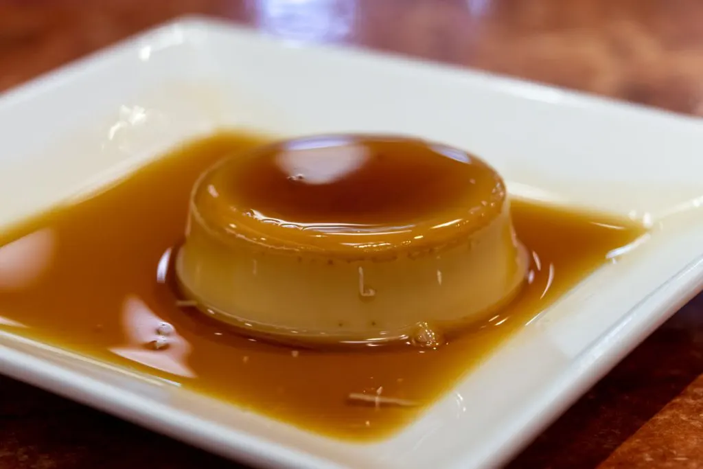 Filipino version of leche flan served on a white plate.