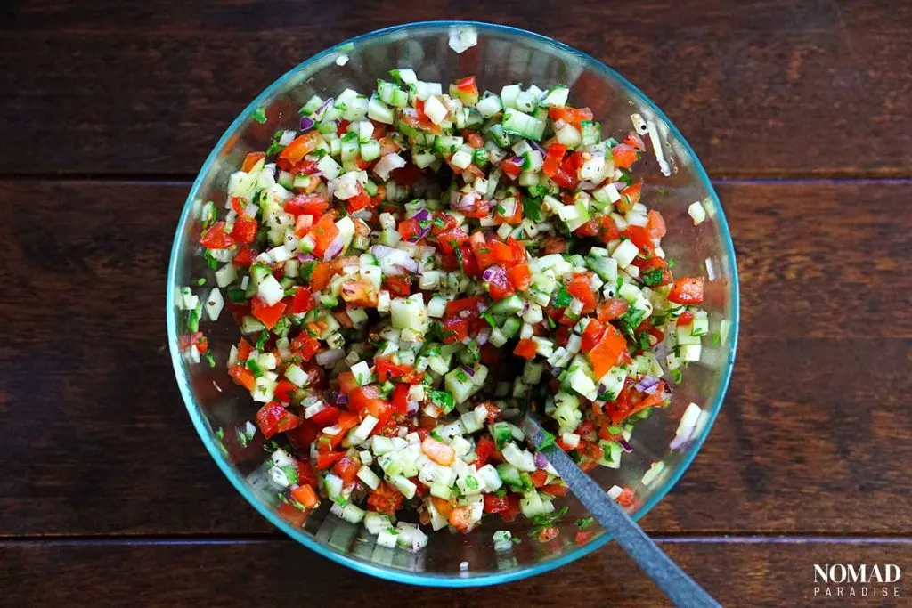 Shirazi Salad (mixing ingredients).