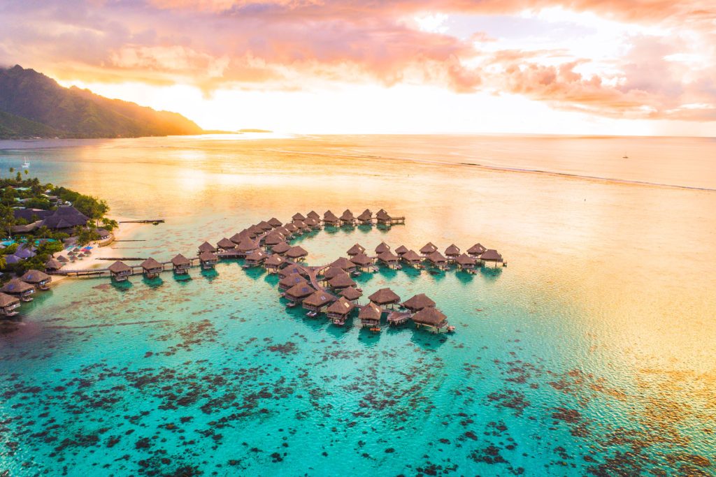 Aerial view of a resort with overwater bungalows.